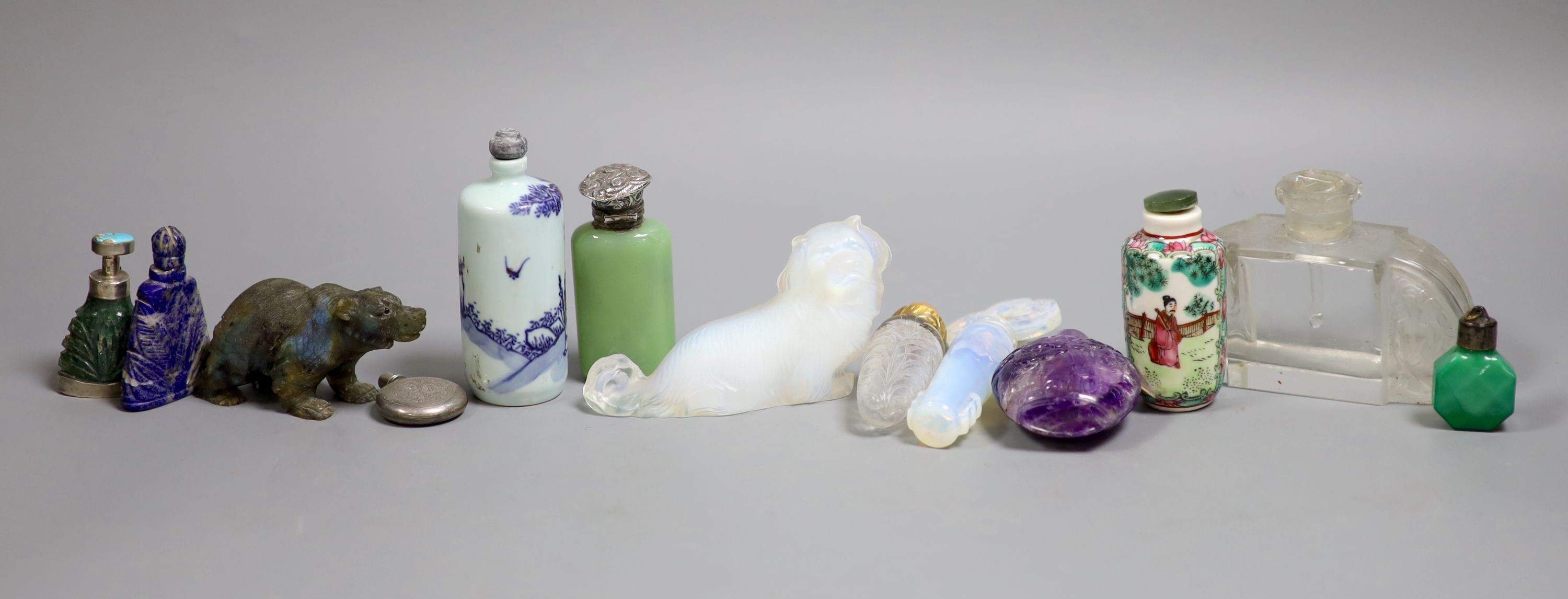 A collection of Chinese snuff bottles and European glass scent bottles, an opalescent glass figure of a dog etc.